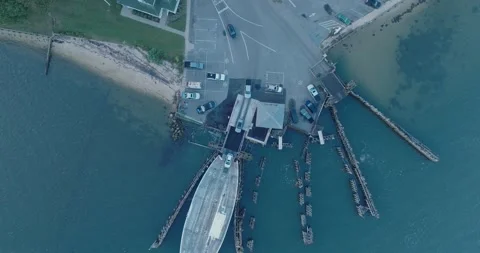 Top Down Aerial Drone shot of Shelter Island New York Ferry unloading at sunrise Stock Footage 255472503