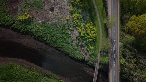 Top-down aerial drone shot capturing a car driving along the A83 road Stockbeeldmateriaal 337022452
