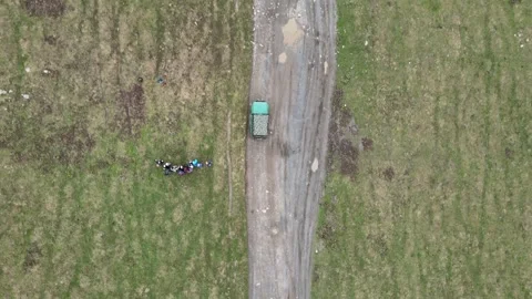 Top-down aerial drone shot of an off-road car on a dirt road Vídeos de archivo 337712635