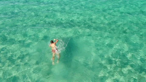 Top Down Aerial Drone View Of A Sea Swimmer Swimming And Training Towards Stock-Footage 121250002