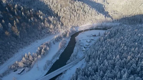 Top Down Aerial Drone View above Snow Covered Forest and curved Highway Stock Footage 170013822