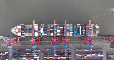 Top down aerial drone view on a shipping container terminal. Large carrier Stock Footage 260314489