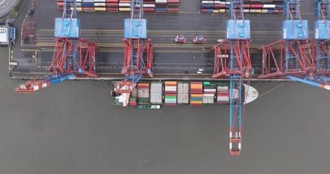 Top down aerial drone view on a container ship loading and unloaded by large Stock Footage 262148868