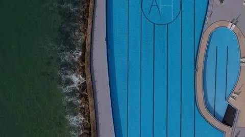 Top down aerial drone view above Praia Grande's seaside swimming pool in Sintra, Stock Footage 290374223