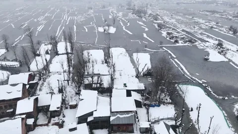 Top down Aerial drone view of dal lake during snowfall, with its vintage houses Stock Footage 310223377