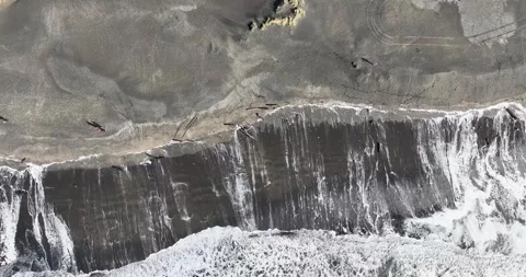 Top-Down Aerial Drone View of Waves Crashing on Sandy Shore Stock Footage 320848637