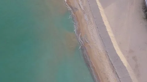 Top-down aerial drone view of sandy beach and turquoise shoreline Stock Footage 322537155
