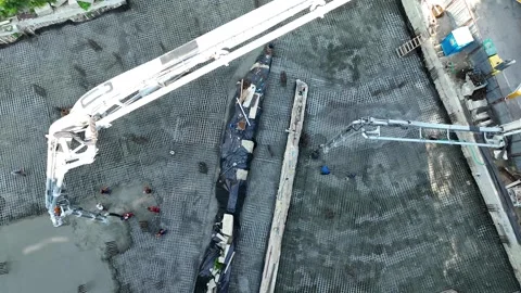 Top-down aerial drone view of a concrete mixer truck discharging cement Stock Footage 326989408