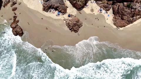 Top Down Aerial Drone View of Waves Breaking on Sandy Beach with Swimmers Stock Footage 329314617