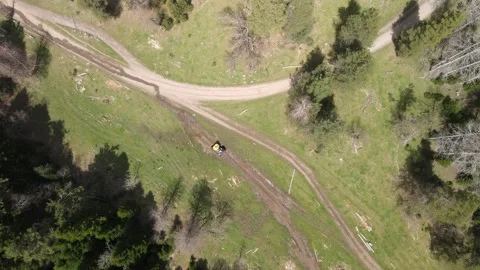 Top-down aerial drone view of a vehicle driving on a rural mountain road Stock Footage 337534308