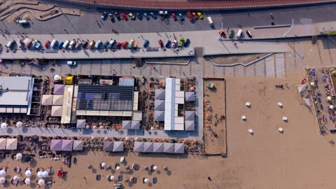 Top-down aerial drone view of a sandy beach resort featuring waterfront Stock Footage 337911011