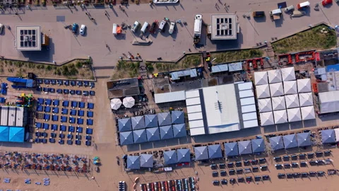 Top-down aerial drone view of structured coastal beach clubs and pavilions Stock Footage 337911169