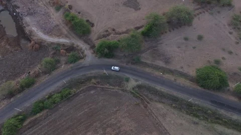 Top Down Aerial Drone View of White Car Driving on Rural Asphalt Road Stock-Footage 338297803