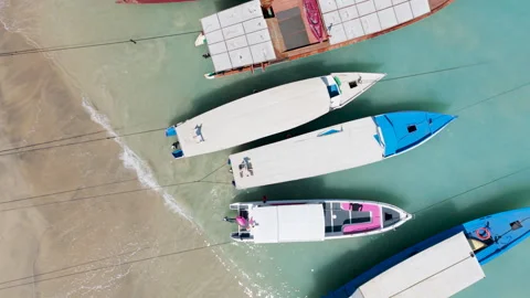 Top Down Aerial Drone View Flying Over Holiday Speedboats at Shore Stock Footage 346797603