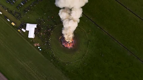 Top Down Aerial Drone View Of Huge Bonfire In Green Field With Crowd And White 動画素材 346936742