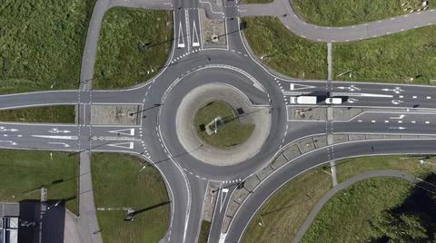 Top down aerial drone view of a small traffic roundabout Stock Photos