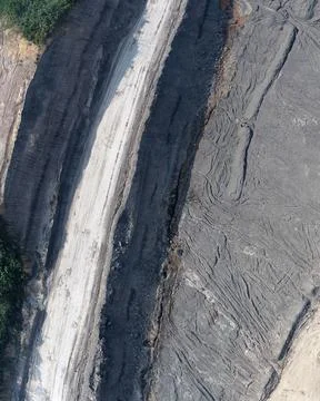 Top-down aerial drone view of a white gravel mining haul road running Stock Photos