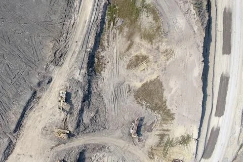 Top-down aerial drone view of an active open-pit mining site Stock Photos