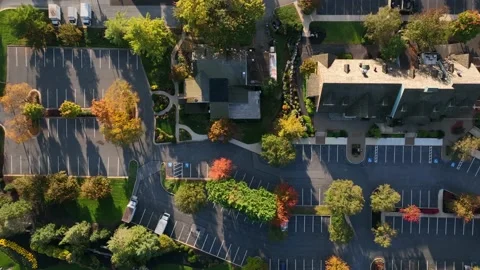 Top down aerial of empty parking lot. Asphalt paving and office buildings Vídeo Stock 231744987