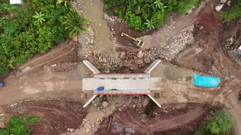 Top down aerial of excavator working on river bridge construction. Stock Footage 340515142