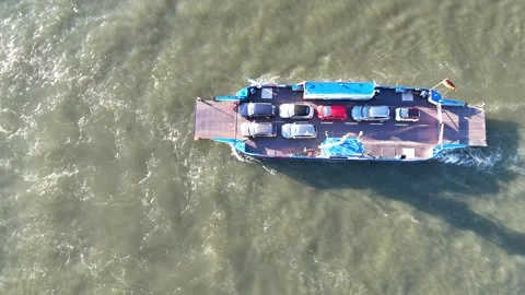 Top down aerial of ferry cutting through river current Stock Footage 341418212