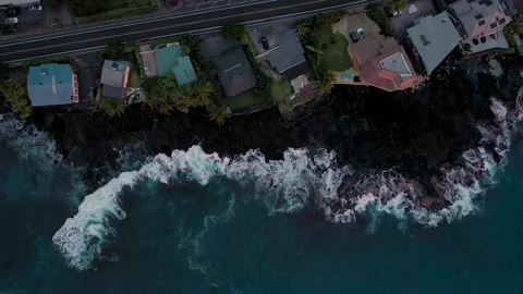 Top-Down Aerial Flight Over Oceanfront Estates on Volcanic Black Rock Shore Stock Footage 328388499