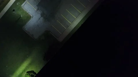 Top Down Aerial Flying Over Warehouse Empty Parking Lot At Night Purple Stock Footage 222988696