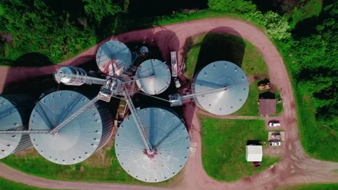 Top down aerial of Hopper Grain Trailer loading from farm silos in Video stock 282361818