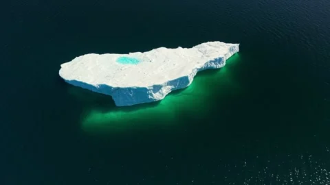 Top Down Aerial Iceberg Turquoise Melt Pool Dark Ocean Newfoundland Video stock 334648953