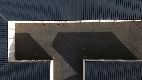 Top Down Aerial of Industrial Rooftop Complex with Geometric Shadows Stock Footage 335209132