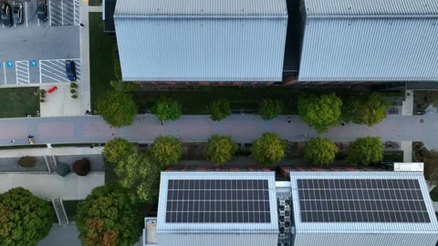 Top down aerial of metal rooftop with solar panel array. Stock Footage 221558877
