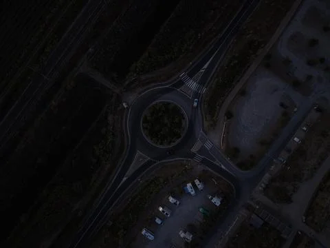 Top-down aerial night view of a roundabout near the Étang de Thau, Sète, France Stock Photos