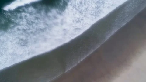 Top Down Aerial of Ocean Wave Breaking on Sand in a Loop The Concept of Tra.. Видео 331925449