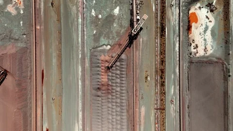 Top down aerial over mining conveyor system in action moving raw iron ore Stock Footage 333282711