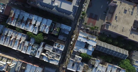 Top down aerial over rowhouse roofs and schoolyard in New York City Video stock 59521974