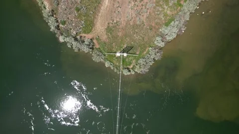 Top down aerial over Snake River riverbank with power lines near Burley Idaho Stock Footage 244053483