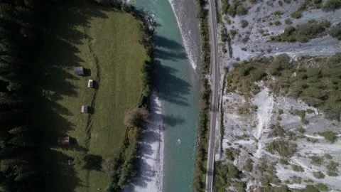 Top down aerial over the wild river Rhine next to a idyllic railway, Switzerland Video stock 162941827