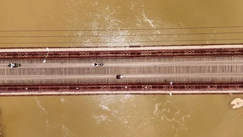 Top Down Aerial Pan Over Bridge Traffic and Brown River, Luang Prabang Stock-Footage 347422158