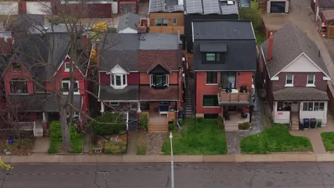 Top down aerial perspective flying over a row of red brick houses in a quiet sub Stock Footage 334697128