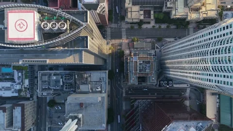 Top down aerial perspective flying over modern skyscrapers and urban grid street Stock Footage 336634387