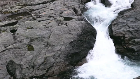 Top down aerial perspective following the course of a clear mountain river .. Stock Footage 323971874