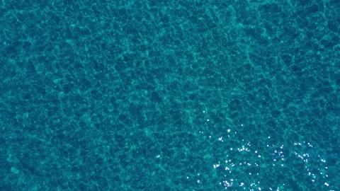 Top down aerial perspective of gentle turquoise waves at Possidii Greece Video stock 348233208