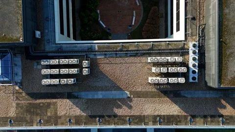 Top down aerial perspective of organized cooling fan arrays on a data centre Stock Footage 333937888