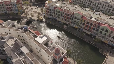 Top Down Aerial Perspective of Venetian Style Canal with Gondola Passing Under Stock Footage 337200065