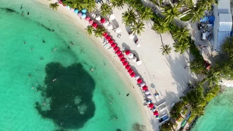 Top Down Aerial of Red Beach Umbrellas on Maafushi Island Maldives 動画素材 332635203