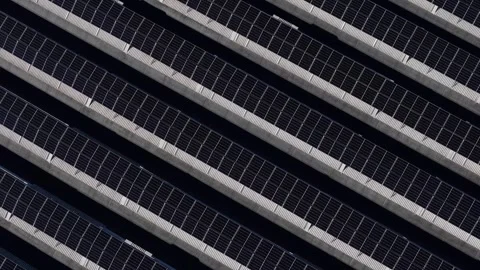 Top down aerial of rooftop solar panel array on industrial warehouse, repeating Stock-Footage 329785516