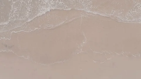 Top Down Aerial of Sandy Beach With small waves crashing Stock Footage 94430919
