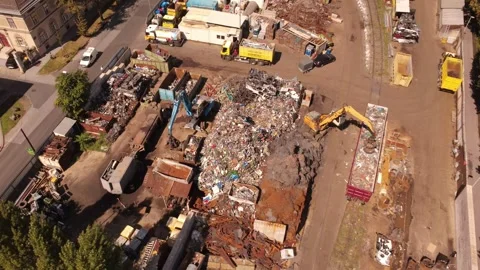 Top down aerial of a scrap metal recycling yard with excavators at work Stock Footage 345393953