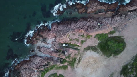 Top down aerial shot of 4x4 on rocky coast, Bowen, Australia Stock Footage 345152241