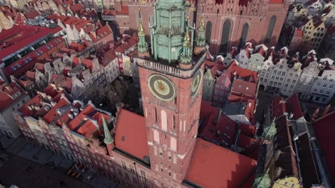 Top down aerial shot of ancient cathedral and clock tower in European town with Stock Footage 230099330